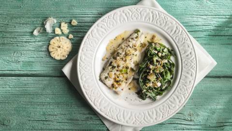 Sea bass with garlic and steamed greens